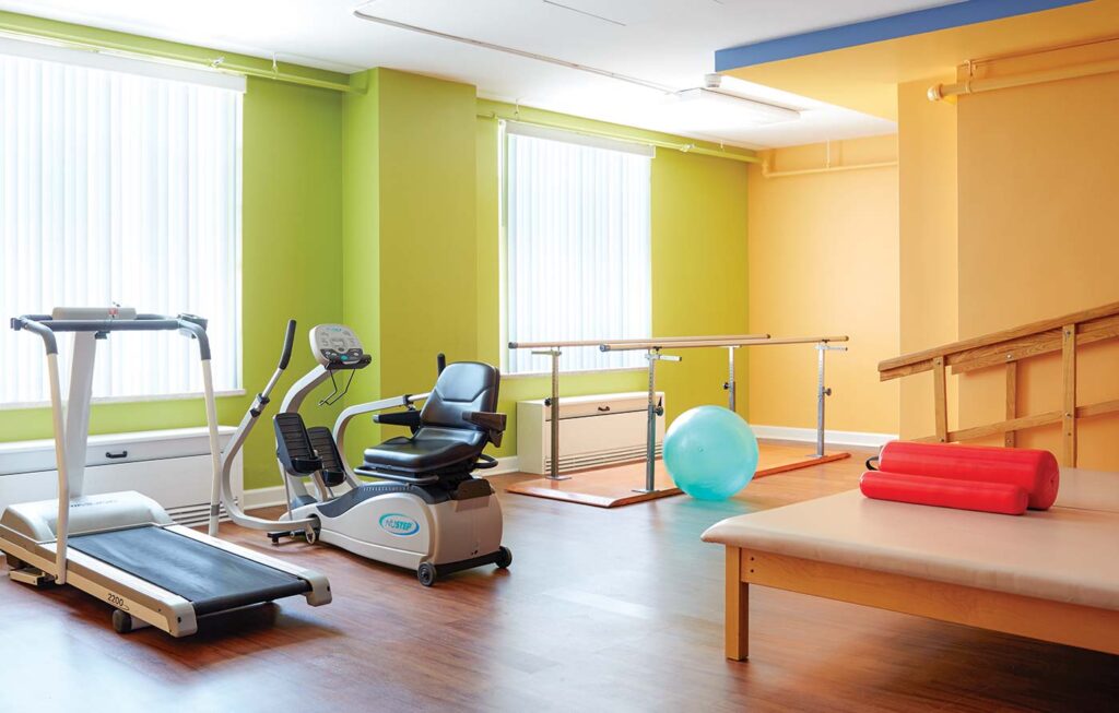 Fitness room for residents with vibrant walls and cardio machines