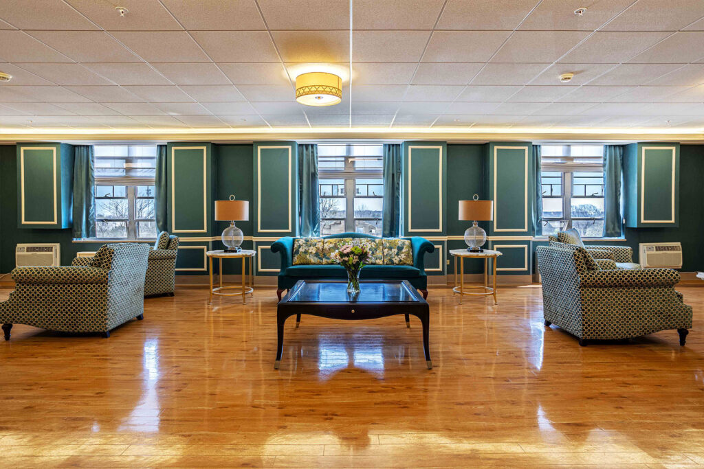 Celebrate Senior Living Niles large lounge are with wooden floors and couches.