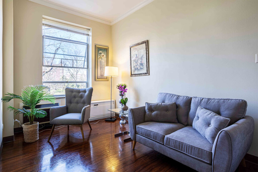 Celebrate Senior Living Niles living room with window and a couch.